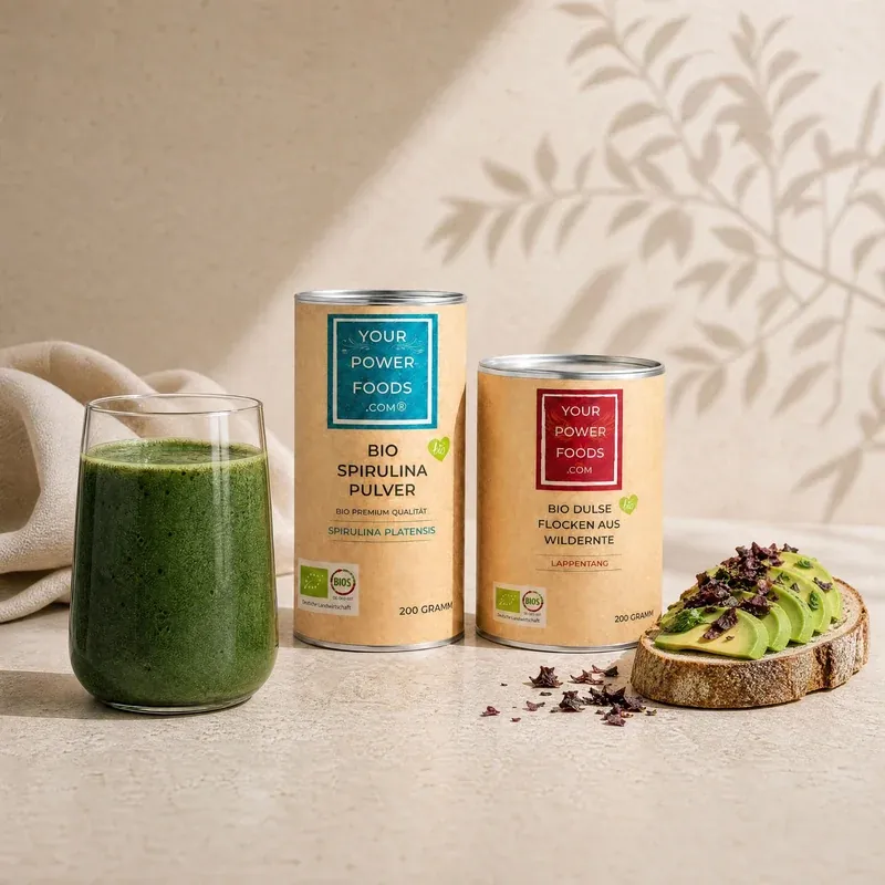 Bio Dulse Flocken 200g & Bio Spirulina Pulver 200g Set als Lifestyle-Szene mit grünem Smoothie, zwei Dosen und Avocadobrot mi