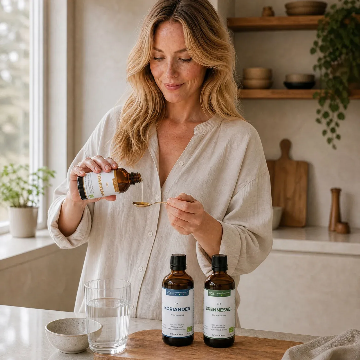 Detox Balance Bundle – Frau in heller Küche dosiert Tropfen aus Braunglasflasche auf Löffel, zwei weitere Fläschchen mit Korian